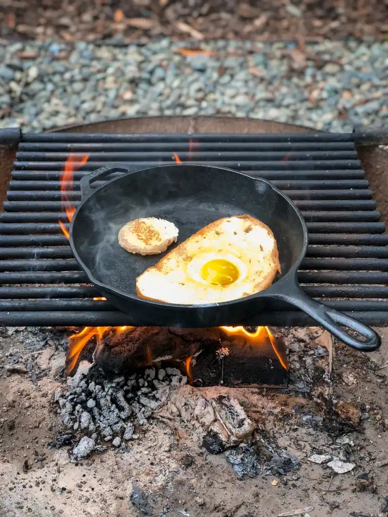 Eggs frying in a cast iron skillet