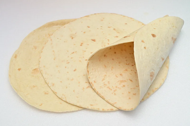 A stack of soft homemade-style flour tortillas