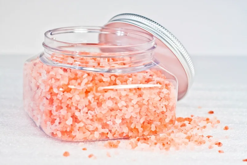 A glass jar of coarse pink Himalayan salt