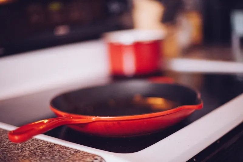 A frying pan heating on a stovetop