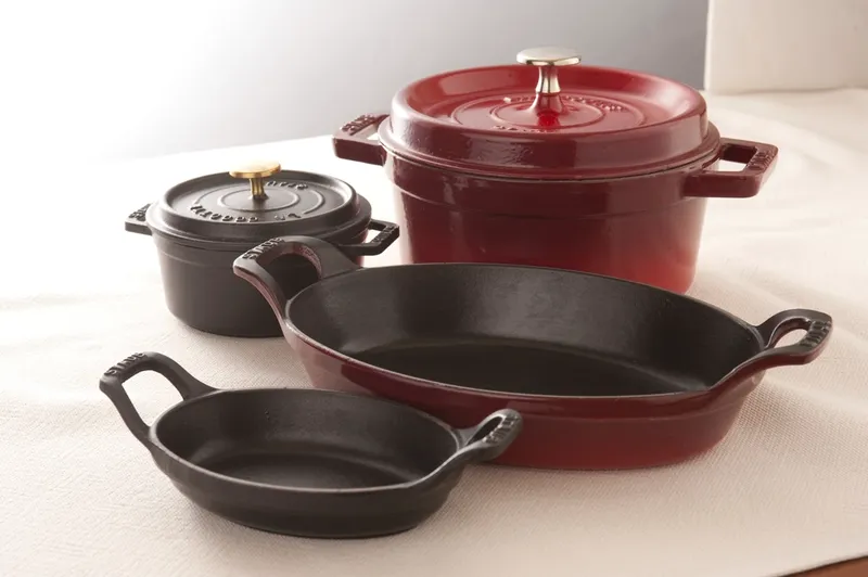 A set of enameled cast iron pots and pans