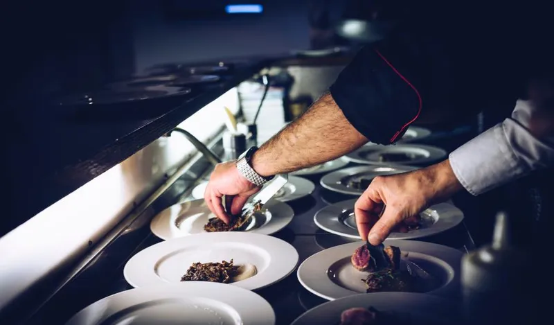 A cook working at a busy stove