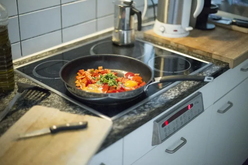 A pan cooking on a home stove