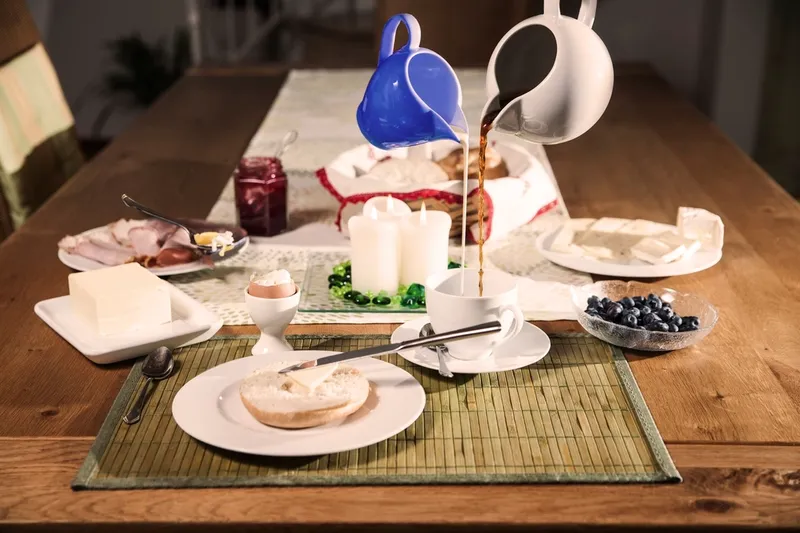 A dinner party table set with plates and dishes